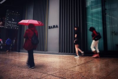 Full length of people walking in rain