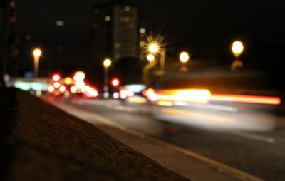 Defocused image of illuminated road at night