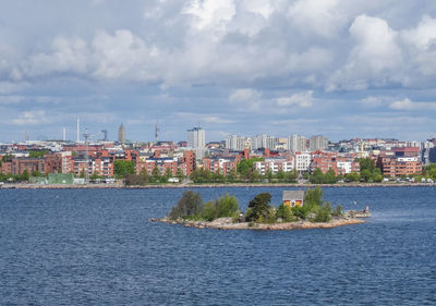 View of cityscape against cloudy sky