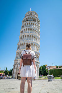 Rear view of women against blue sky