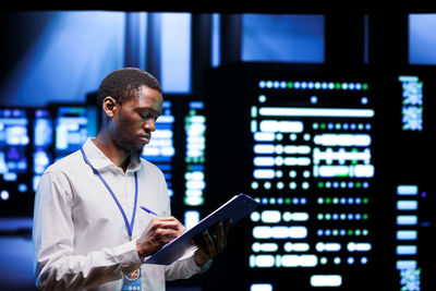 Side view of businessman using laptop at airport