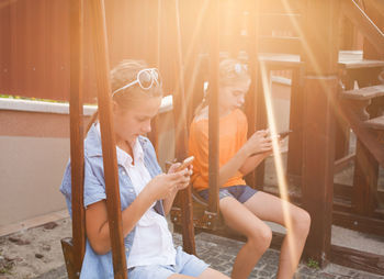 Woman looking at camera while sitting outdoors