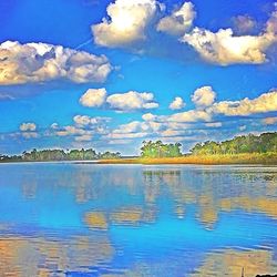 Scenic view of lake against cloudy sky