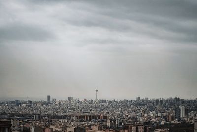Cityscape against cloudy sky