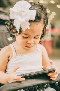 Midsection of a girl playing game on the phone