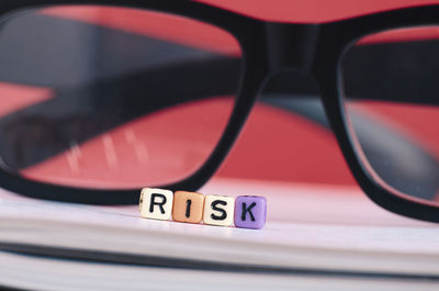 Close-up of risk text and eyeglasses on book