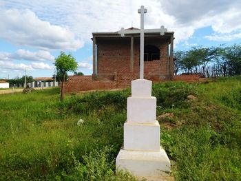 Built structure on field against sky