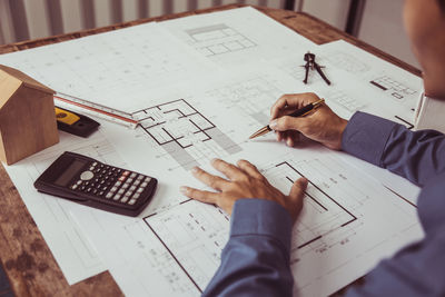 Midsection of business colleagues working at table