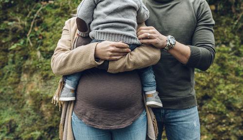 Pregnant woman with family in nature