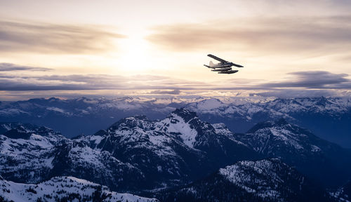 Scenic view of snowcapped mountains against sky during sunset