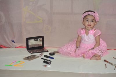 Portrait of cute girl sitting on table