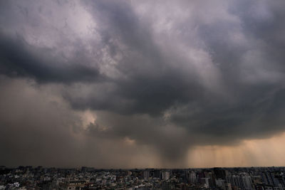 Storm clouds over city buildings