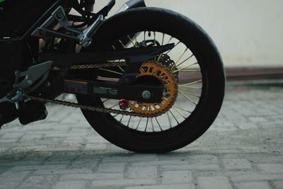 Close-up of motorcycle wheel on street