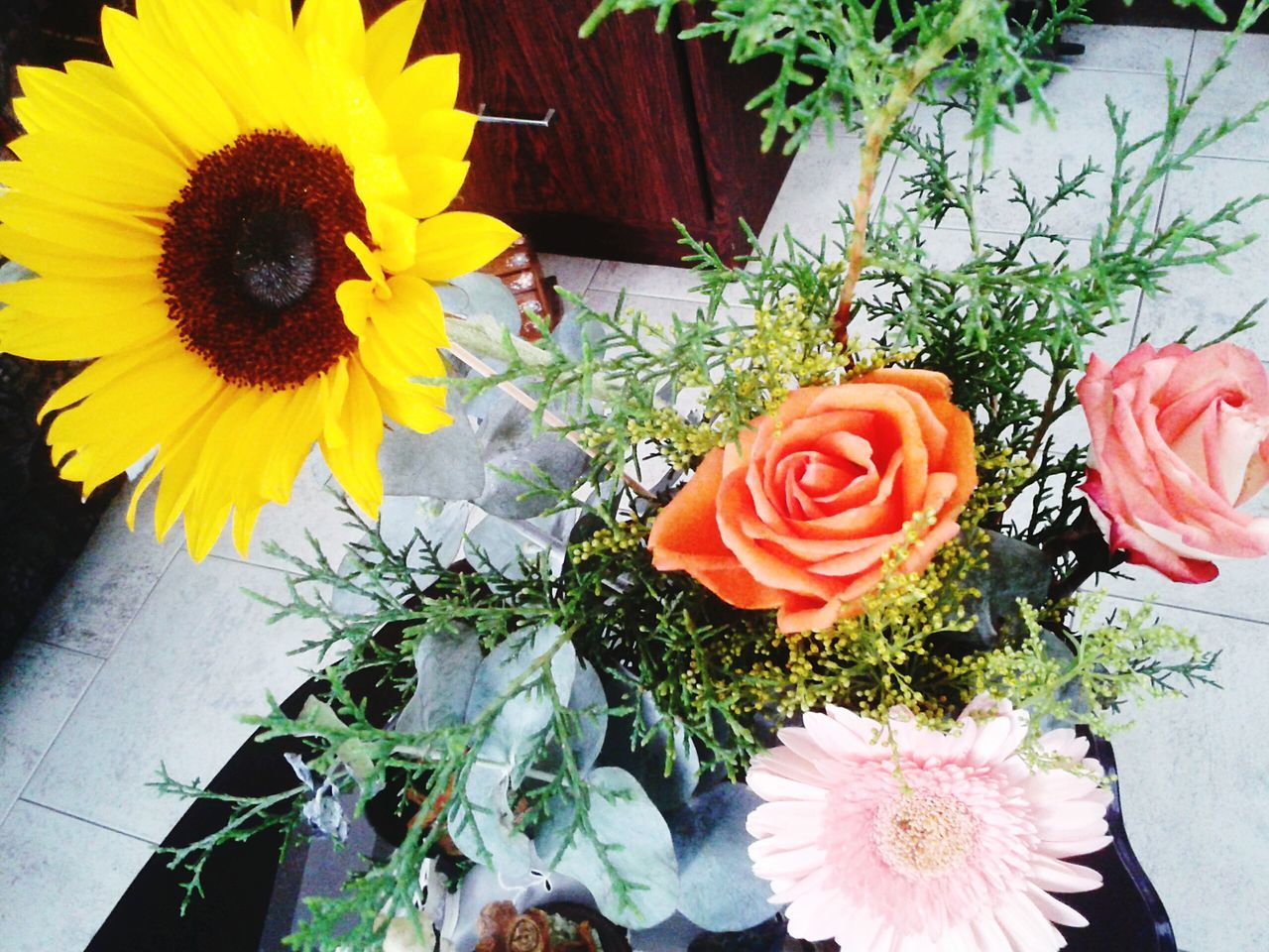 flower, freshness, petal, fragility, flower head, bouquet, indoors, potted plant, vase, yellow, flower arrangement, high angle view, plant, beauty in nature, rose - flower, growth, multi colored, decoration, table, bunch of flowers