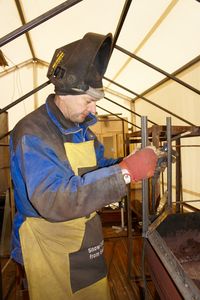 Manual worker working at metal workshop