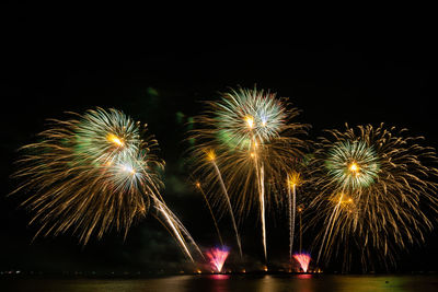 Low angle view of firework display at night