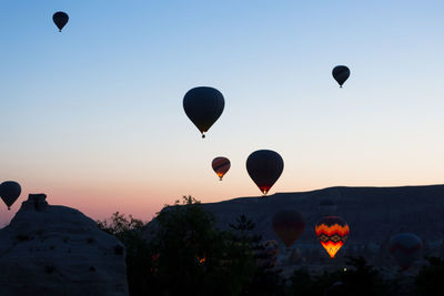 Hot air balloons flying in sky during sunset