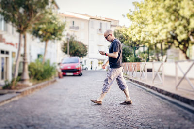 Full length of man on street in city