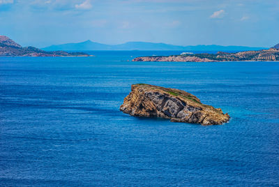 Rock formation in sea against sky