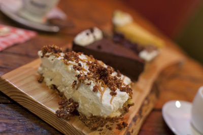 Close-up of sweet food served on wooden cutting board