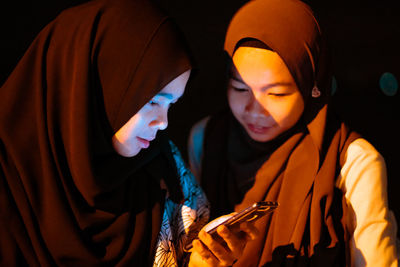 Teenage girl with friend using phone 