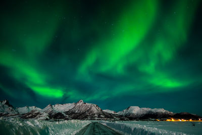 Scenic view of snowcapped mountains against sky at night