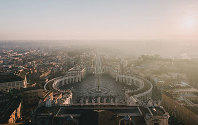 High angle view of st peter basilica in city against sky during sunset
