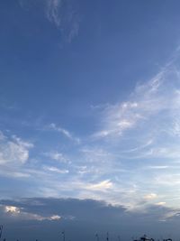 Low angle view of sunlight streaming through clouds