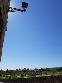 Low angle view of buildings against clear blue sky