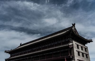 Low angle view of building against cloudy sky
