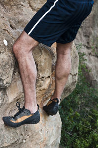 Low section of man climbing on mountain