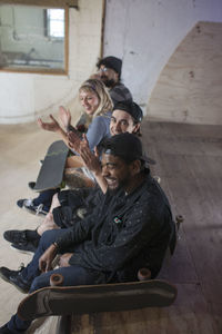 Group of young adults at skating rink.