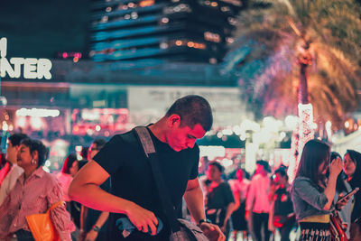 Group of people in city at night