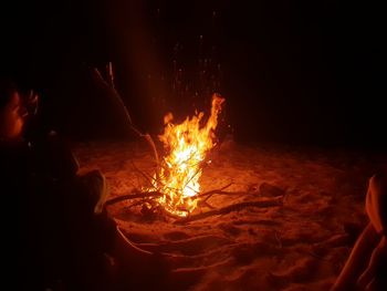 People burning in fire at night