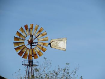 Low angle view of traditional windmill against sky