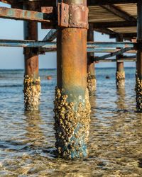 View of rusty pier over sea