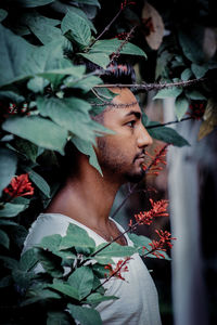 Portrait of young man looking away outdoors