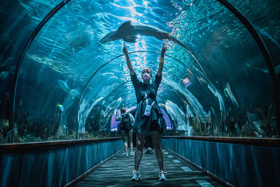 Rear view of people at aquarium