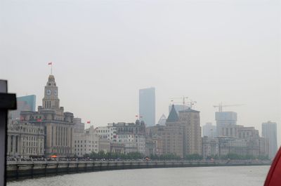 Buildings in city against clear sky