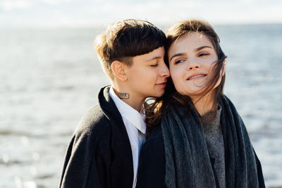 Portrait of happy friends at beach