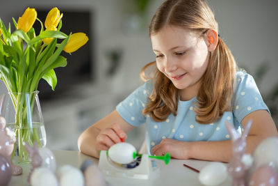 Close-up of girl playing with toys at home