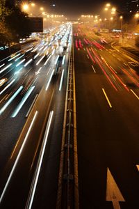 High angle view of light trails on highway at night