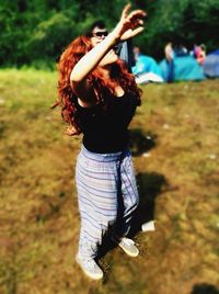 Young woman standing on field