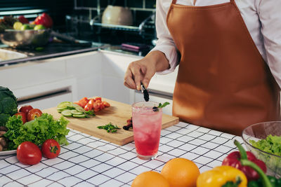 Midsection of man preparing food in kitchen at home