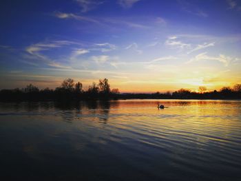 Scenic view of lake against sky during sunset