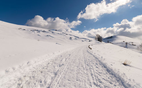 Scenic view of snow covered mountains against sky