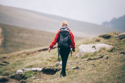 Rear view of man walking on mountain