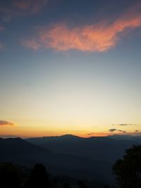 Scenic view of silhouette mountains against romantic sky at sunset