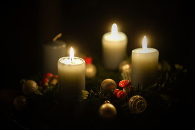 Close-up of illuminated candles on table