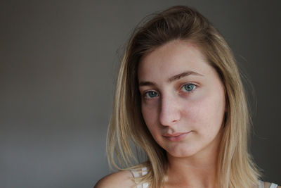 Portrait of a beautiful young woman over black background